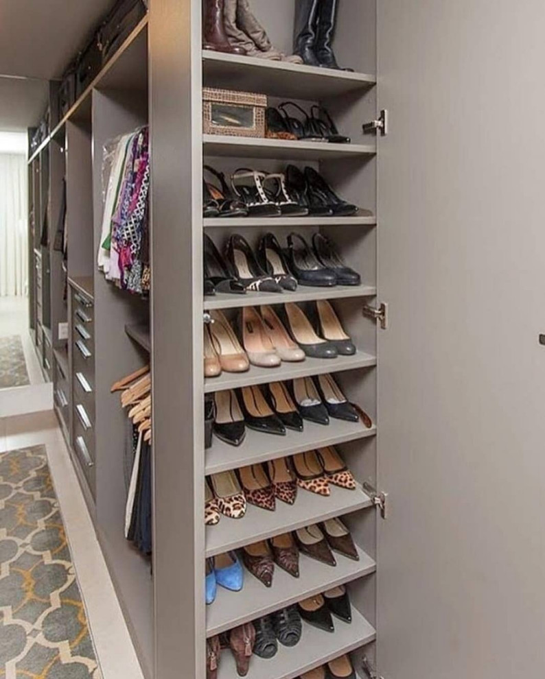 This is an example of a contemporary wardrobe with slate flooring.