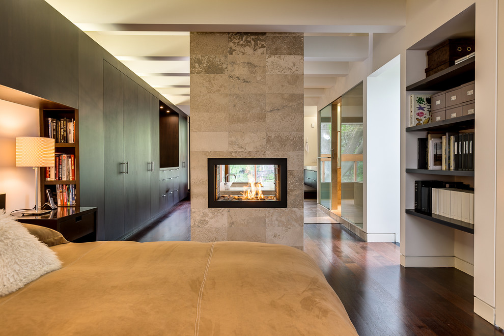 Example of a trendy bedroom design in Toronto with a tile fireplace and a two-sided fireplace