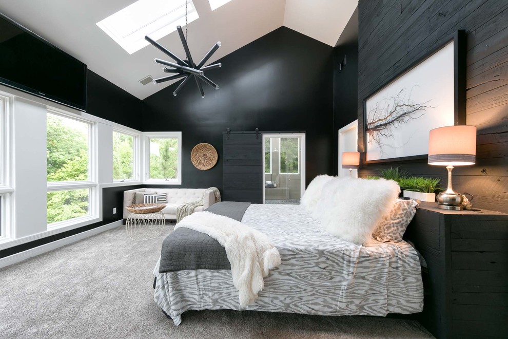 This is an example of a contemporary master bedroom in Nashville with black walls and carpet.
