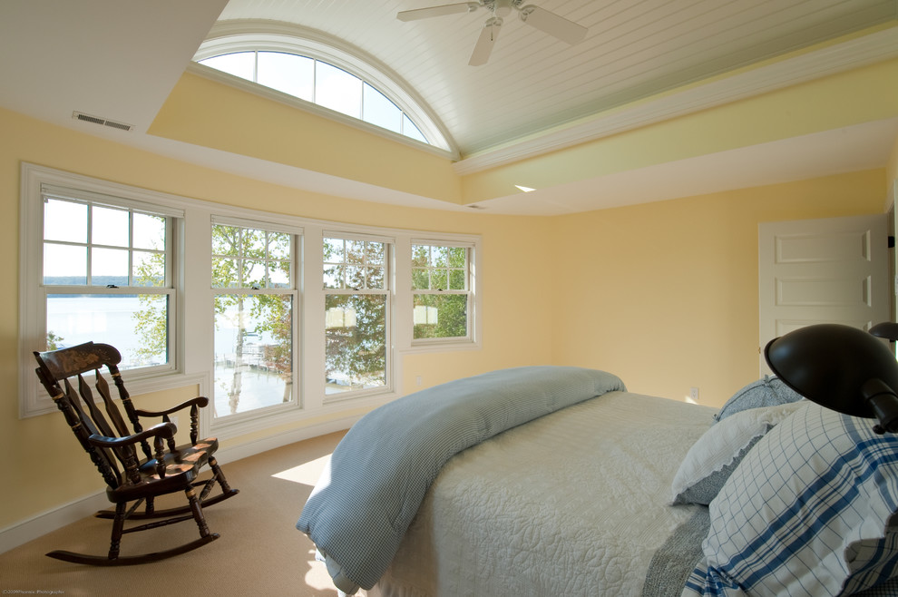 Photo of a large classic guest bedroom in Other with yellow walls, carpet, beige floors and a wood ceiling.