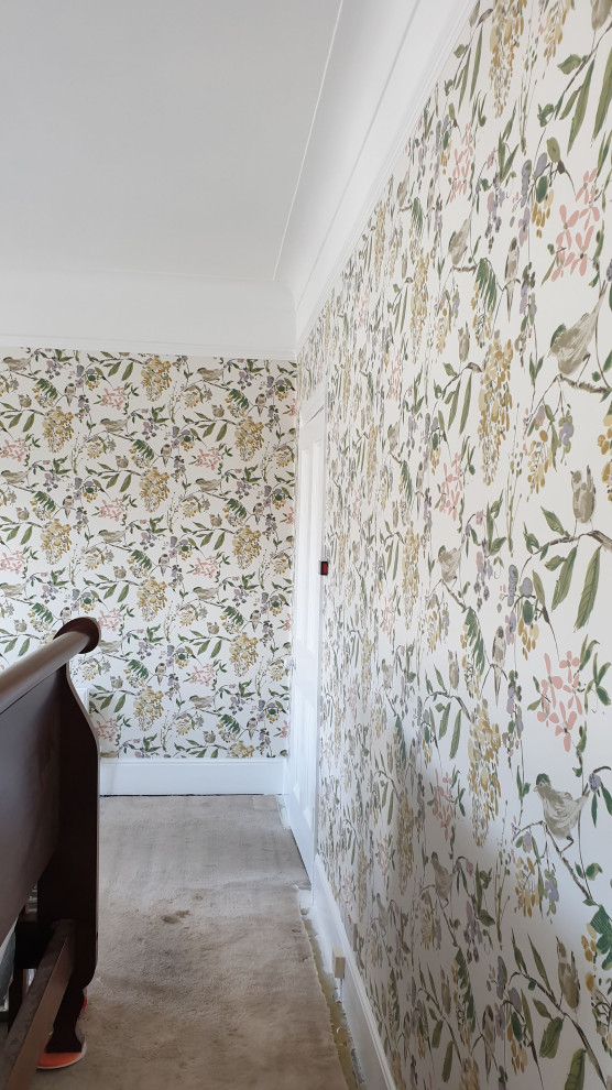 Inspiration for a large timeless master carpeted, green floor, tray ceiling and wallpaper bedroom remodel in London with green walls, a standard fireplace and a stone fireplace