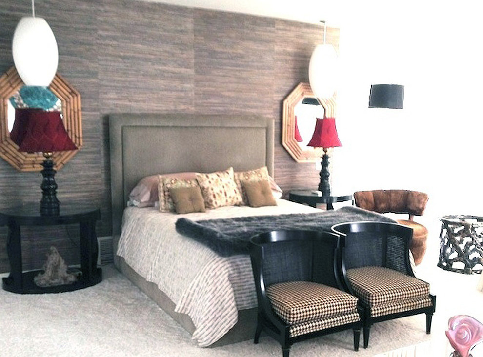This is an example of a world-inspired guest bedroom in Los Angeles with beige walls and carpet.
