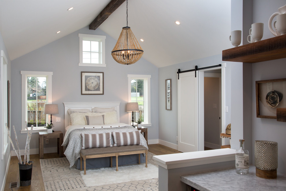Inspiration for a large cottage master medium tone wood floor and brown floor bedroom remodel in San Francisco with blue walls and no fireplace