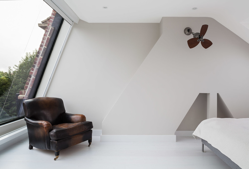 Photo of a contemporary grey and brown bedroom in London with grey walls and white floors.