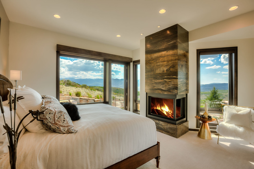 Mid-sized transitional master carpeted and white floor bedroom photo in Salt Lake City with white walls, a two-sided fireplace and a tile fireplace