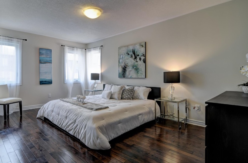 This is an example of a medium sized classic master bedroom in Toronto with beige walls, dark hardwood flooring and brown floors.