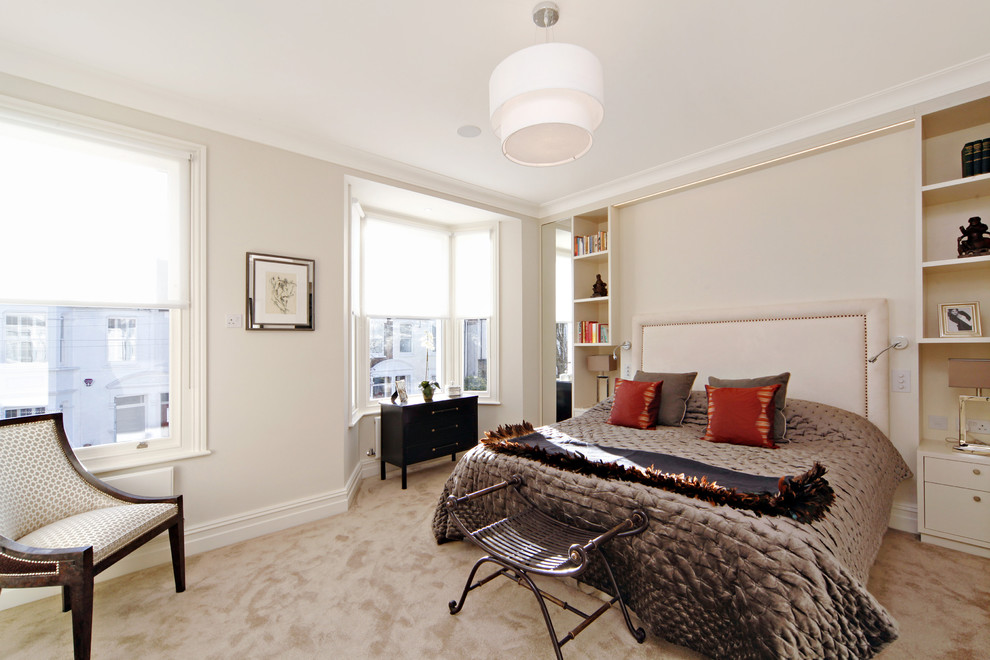 Design ideas for a medium sized contemporary master bedroom in London with beige walls, carpet and no fireplace.