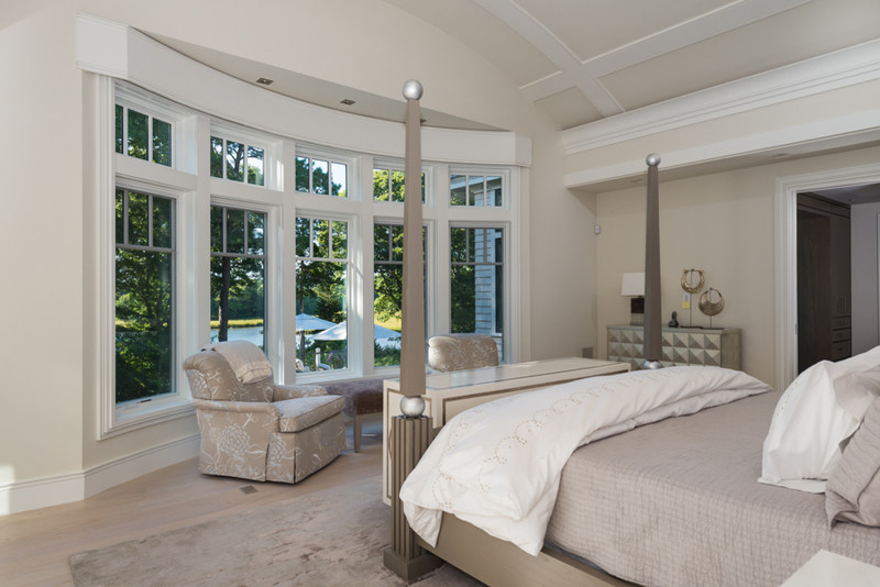 Photo of a medium sized traditional bedroom in Boston with beige walls, light hardwood flooring and no fireplace.
