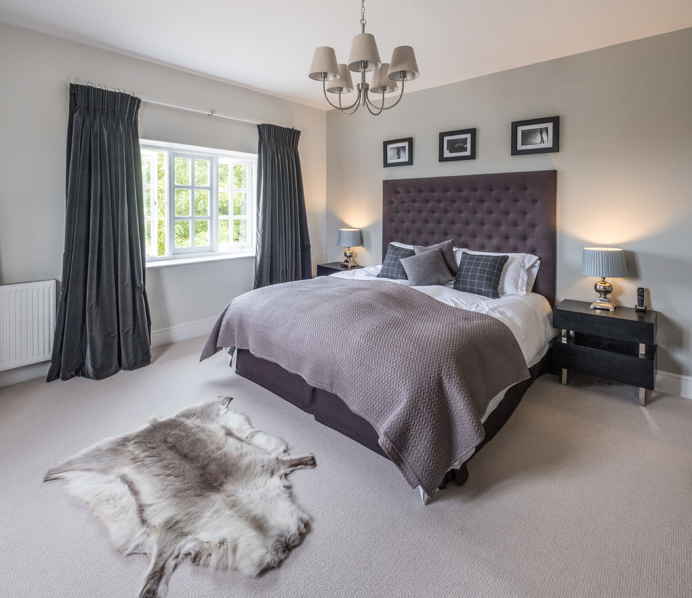 Inspiration for a large traditional master bedroom in Hampshire with grey walls, carpet and white floors.