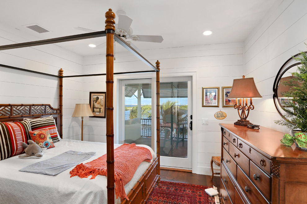 Inspiration for a tropical dark wood floor and brown floor bedroom remodel in Orlando with white walls