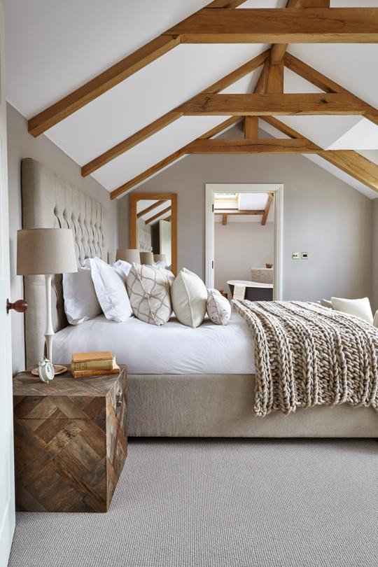 Design ideas for a medium sized nautical guest bedroom in Devon with beige walls, carpet, beige floors and exposed beams.