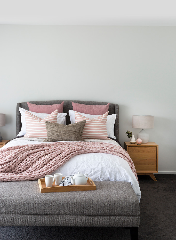 Scandi grey and pink bedroom in Brisbane with white walls, carpet, black floors and feature lighting.
