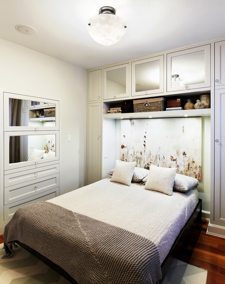 This is an example of a contemporary bedroom in Toronto with white walls and feature lighting.