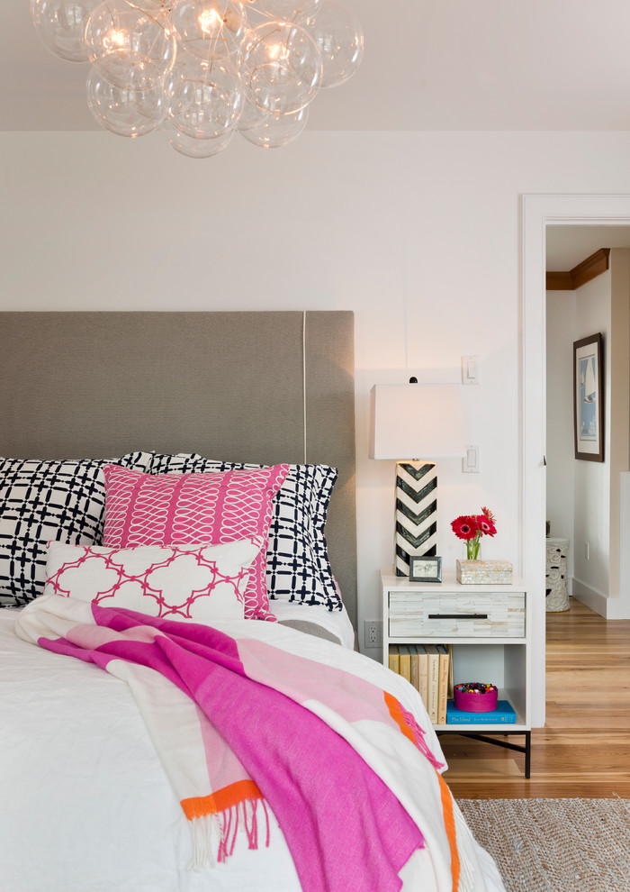 Inspiration for a timeless medium tone wood floor bedroom remodel in Providence with white walls