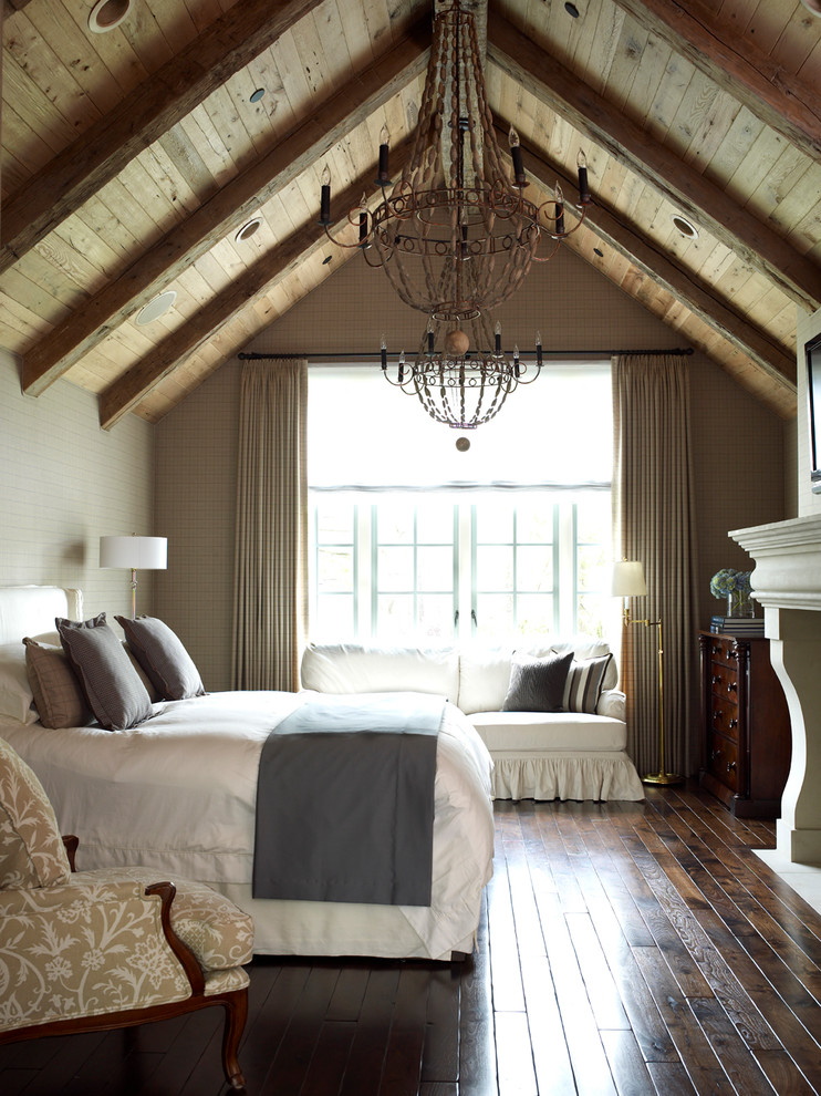 Design ideas for a large farmhouse bedroom in Houston with grey walls, dark hardwood flooring, a standard fireplace and a stone fireplace surround.