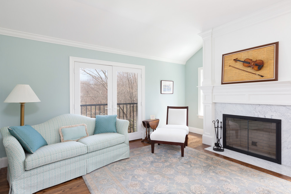 Mittelgroßes Klassisches Hauptschlafzimmer mit grüner Wandfarbe, braunem Holzboden, Kamin, Kaminumrandung aus Stein und braunem Boden in Boston