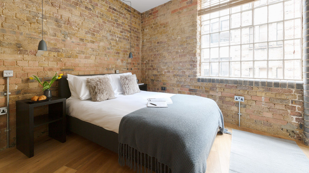 Photo of a medium sized urban bedroom in London with brown walls.
