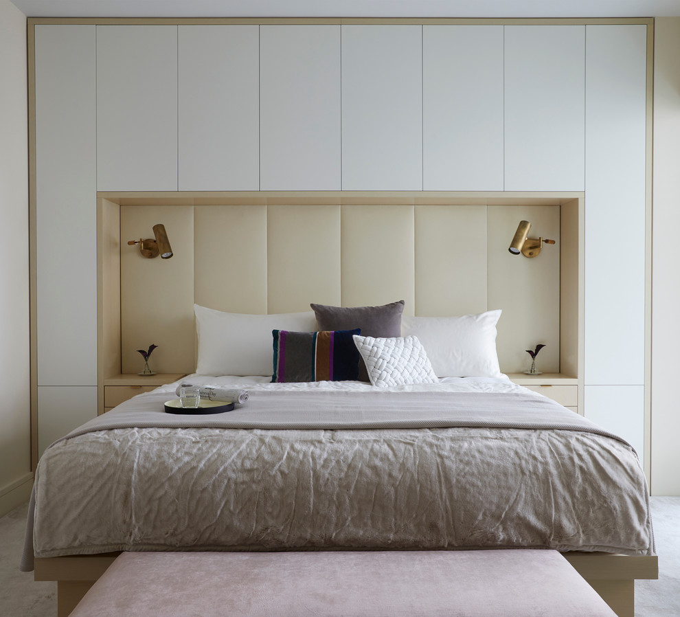 Trendy carpeted and beige floor bedroom photo in New York with beige walls