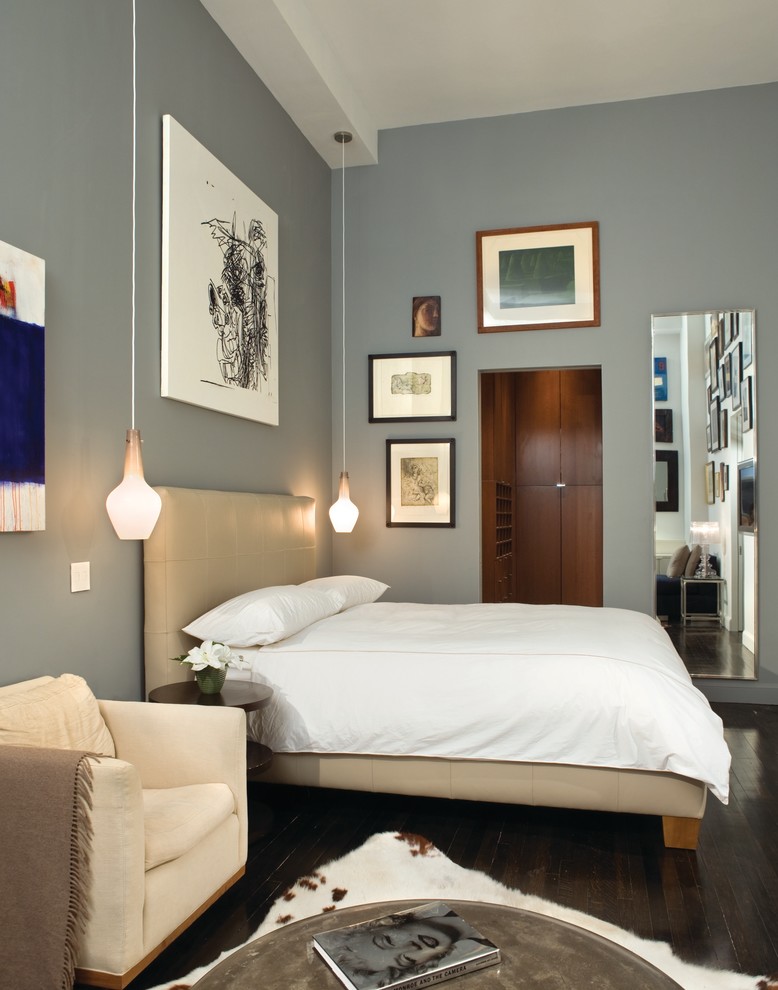 Modelo de dormitorio principal contemporáneo de tamaño medio sin chimenea con paredes azules, suelo de madera oscura y suelo marrón