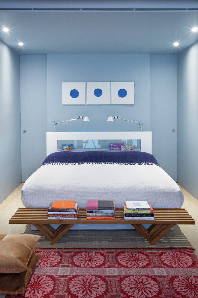 Diseño de dormitorio industrial con paredes azules y suelo de madera clara
