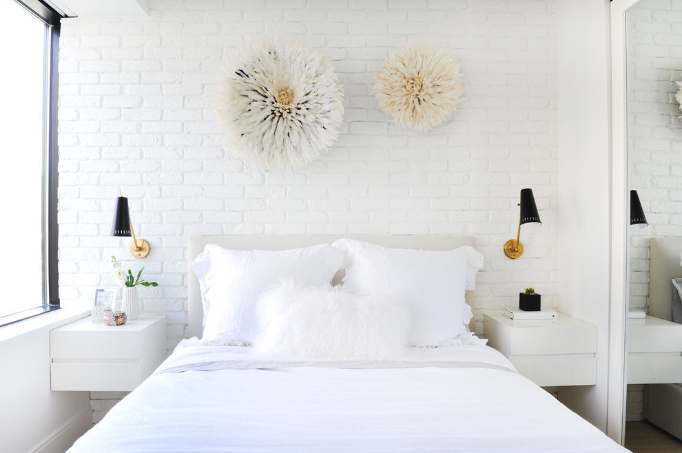Example of a small trendy guest light wood floor and beige floor bedroom design in Vancouver with white walls and no fireplace
