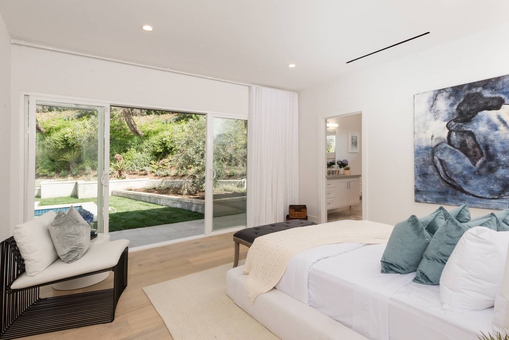 Inspiration for a contemporary light wood floor and beige floor bedroom remodel in Los Angeles with white walls