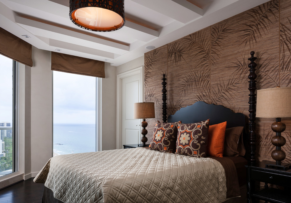 Example of a mid-sized island style guest dark wood floor and brown floor bedroom design in Miami with beige walls