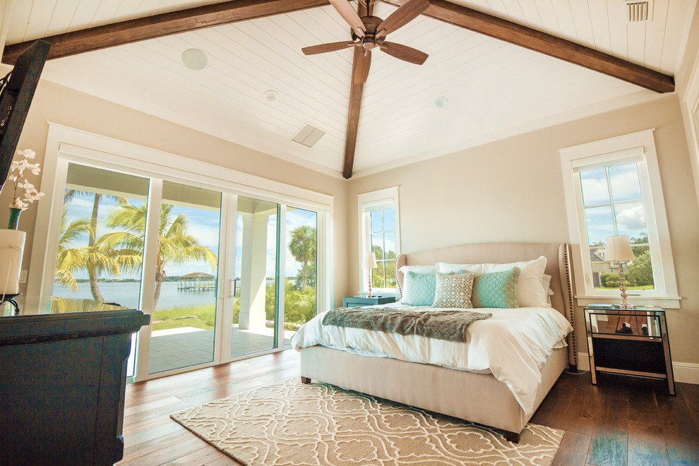 Bedroom - large coastal master medium tone wood floor bedroom idea in Orlando with beige walls and no fireplace