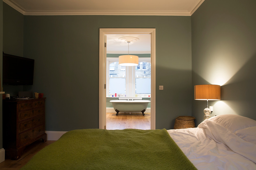 Example of a mid-sized classic master bedroom design in London with green walls