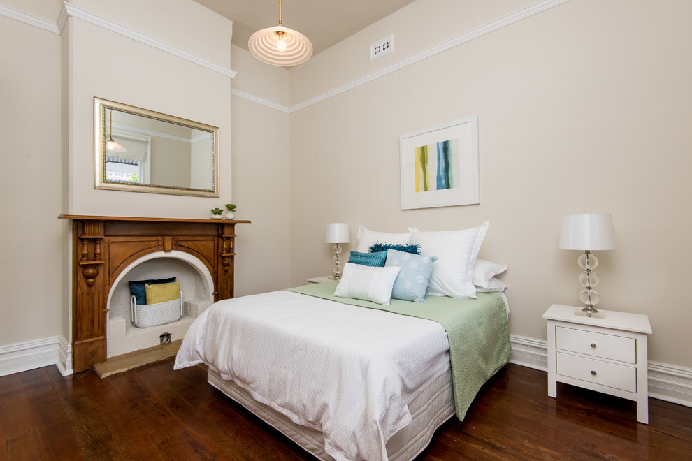 Example of a mid-sized trendy master light wood floor bedroom design in Perth with beige walls, a standard fireplace and a wood fireplace surround