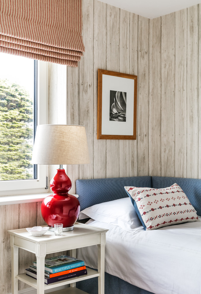 Example of a small beach style bedroom design in London with beige walls