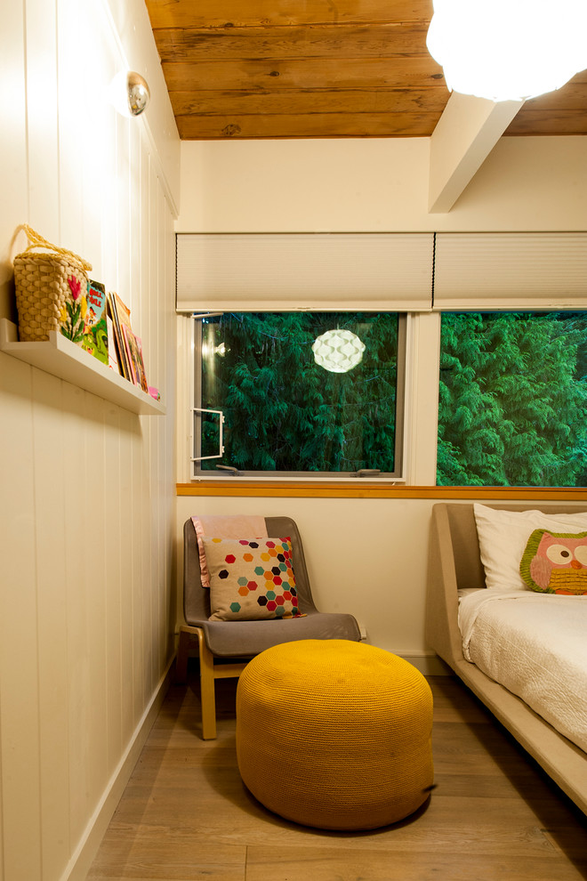 Example of a small 1950s guest medium tone wood floor bedroom design in Vancouver with white walls