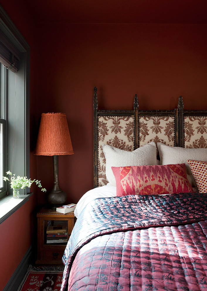 Inspiration for an eclectic master bedroom remodel in New York with red walls