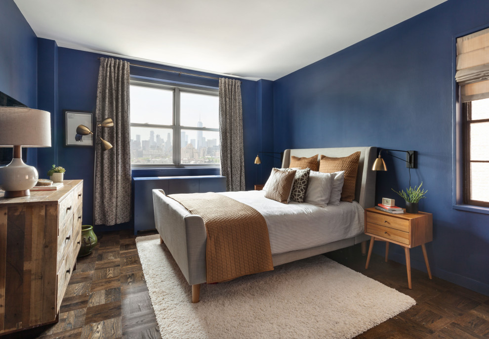 Photo of a traditional grey and brown bedroom in New York with blue walls, dark hardwood flooring and brown floors.