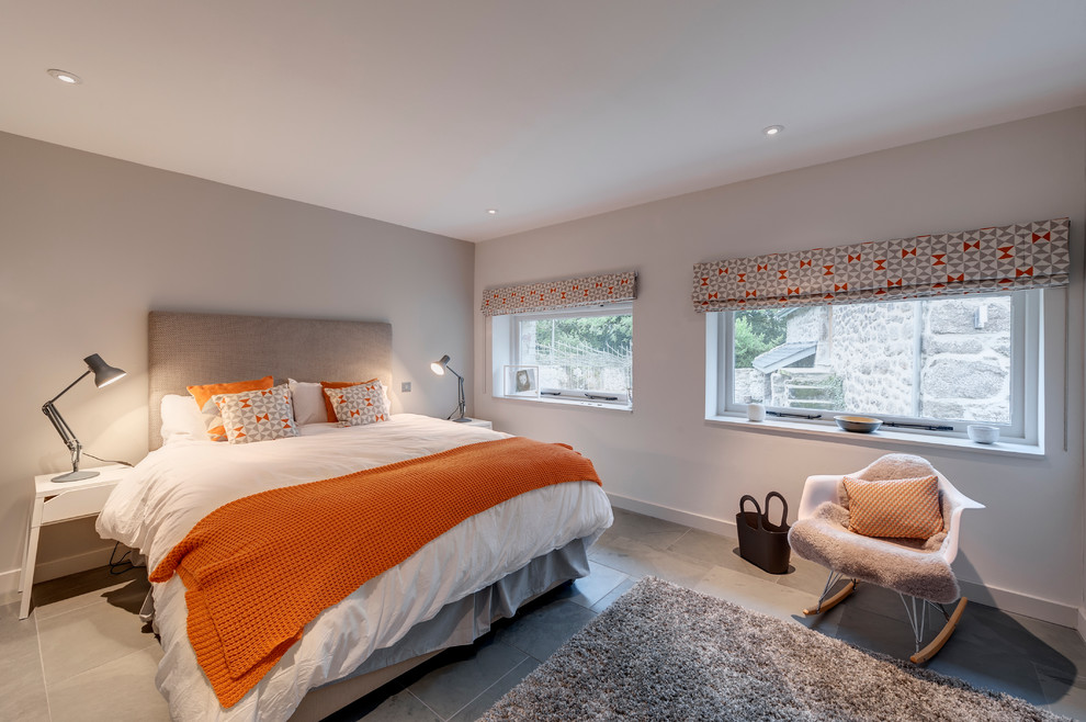 Bedroom - mid-sized contemporary master ceramic tile and gray floor bedroom idea in Devon with gray walls