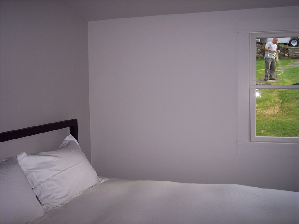 Esempio di una piccola camera degli ospiti contemporanea con pareti grigie, parquet scuro e pavimento marrone