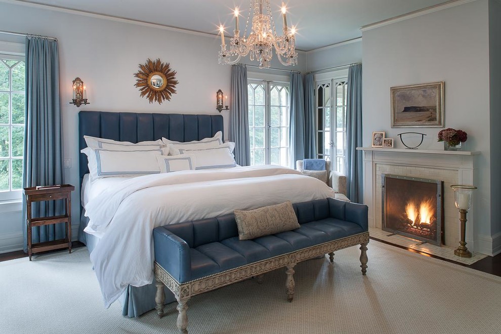 На фото: хозяйская спальня среднего размера в классическом стиле с синими стенами, темным паркетным полом, стандартным камином и фасадом камина из кирпича с