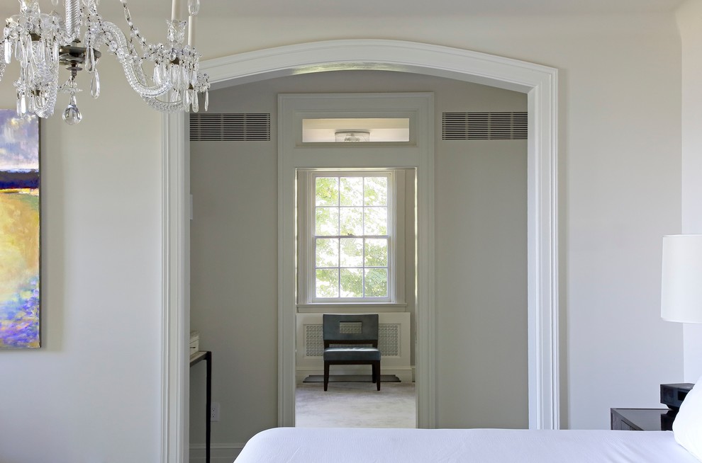 Стильный дизайн: большая хозяйская спальня в стиле неоклассика (современная классика) с белыми стенами, темным паркетным полом, стандартным камином и фасадом камина из камня - последний тренд