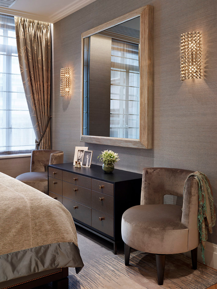 Design ideas for a medium sized classic master bedroom in London with beige walls and light hardwood flooring.