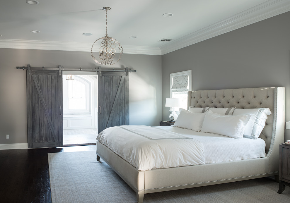 Expansive classic master and grey and silver bedroom in New York with grey walls.