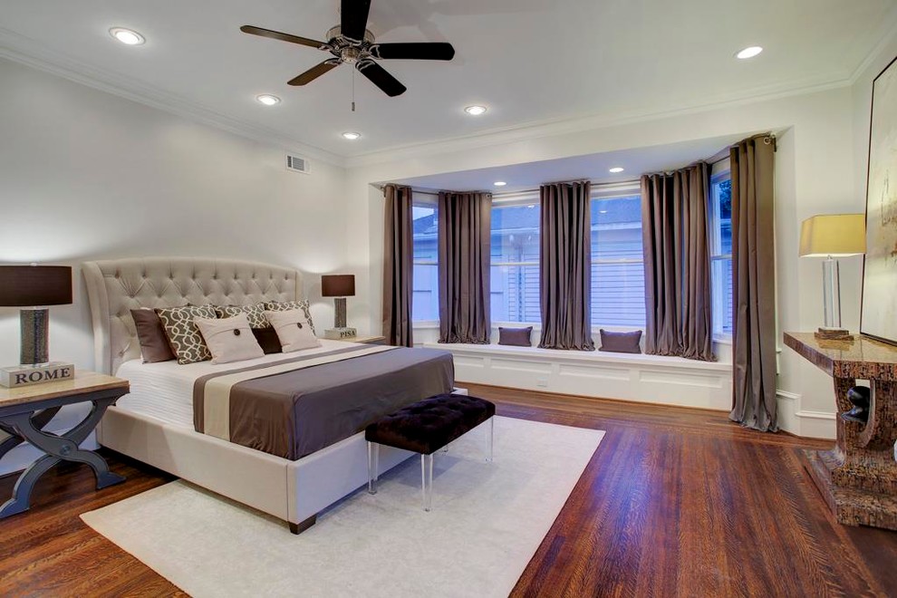 Inspiration for a large victorian master medium tone wood floor bedroom remodel in Houston with beige walls and no fireplace