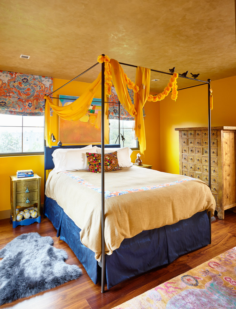 На фото: спальня в стиле фьюжн с желтыми стенами и паркетным полом среднего тона с