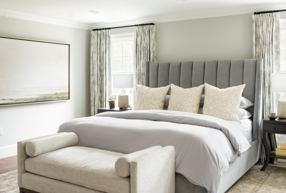 This is an example of a traditional bedroom in Boston with grey walls and no fireplace.