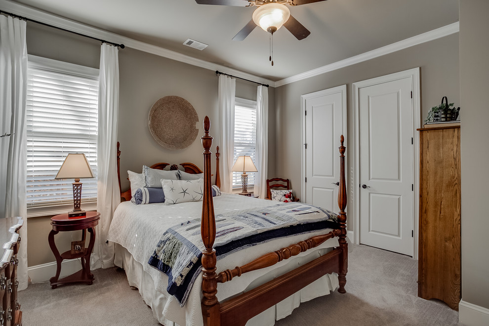 This is an example of a medium sized bohemian guest bedroom in Atlanta with grey walls, carpet and grey floors.