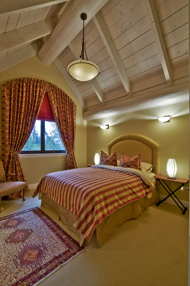 This is an example of a traditional bedroom in Vancouver with beige walls and carpet.