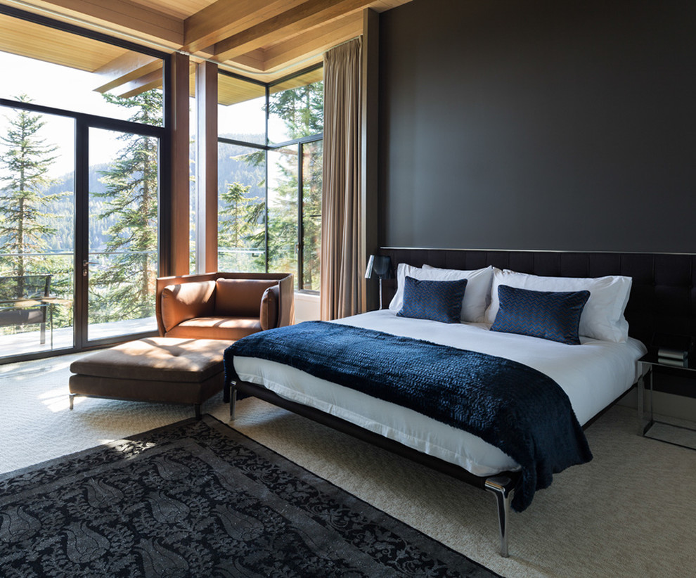 Design ideas for a large contemporary master bedroom in Vancouver with beige walls, carpet, a stone fireplace surround and grey floors.