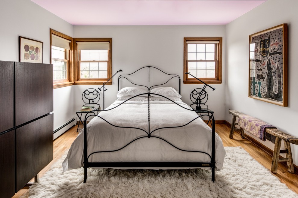 Bohemian grey and pink bedroom in Boston with white walls.