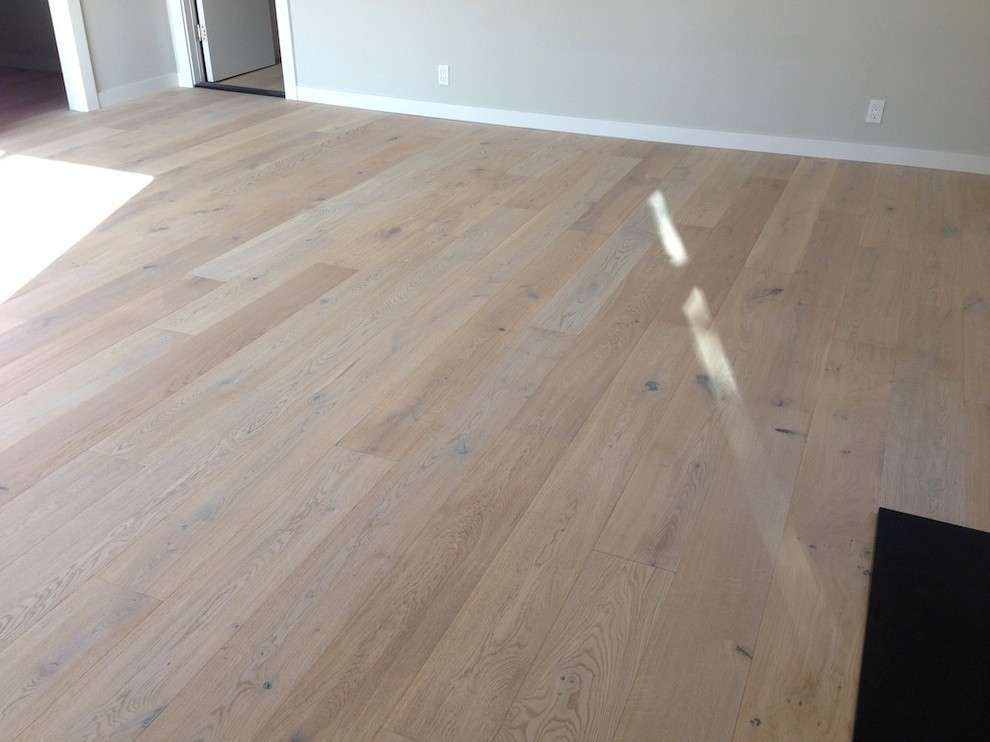 Example of a large transitional light wood floor bedroom design in San Francisco with gray walls