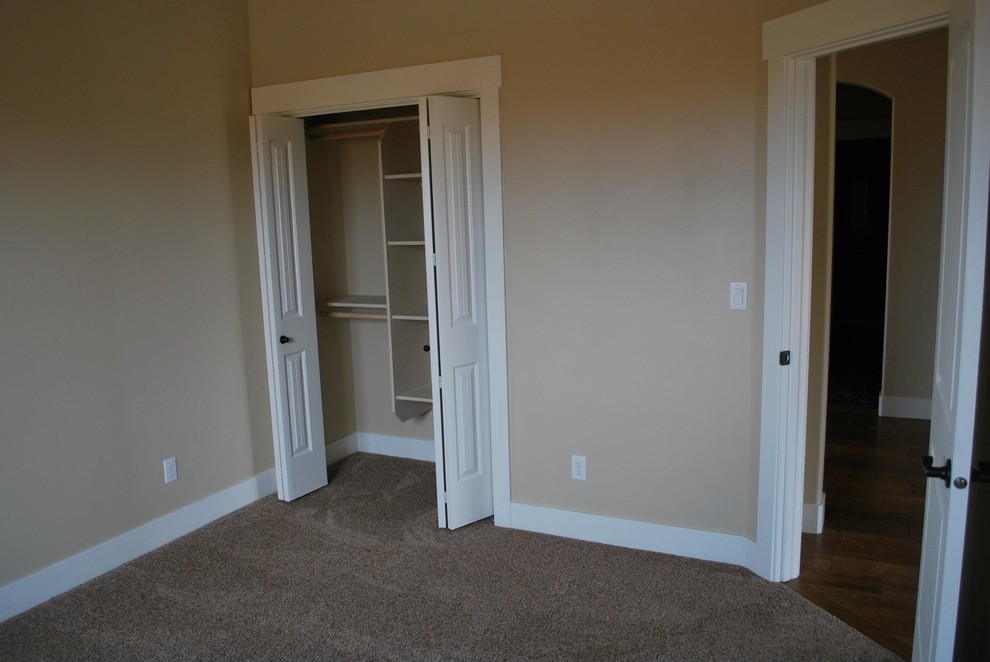 Design ideas for a medium sized traditional guest bedroom in Boise with beige walls and carpet.