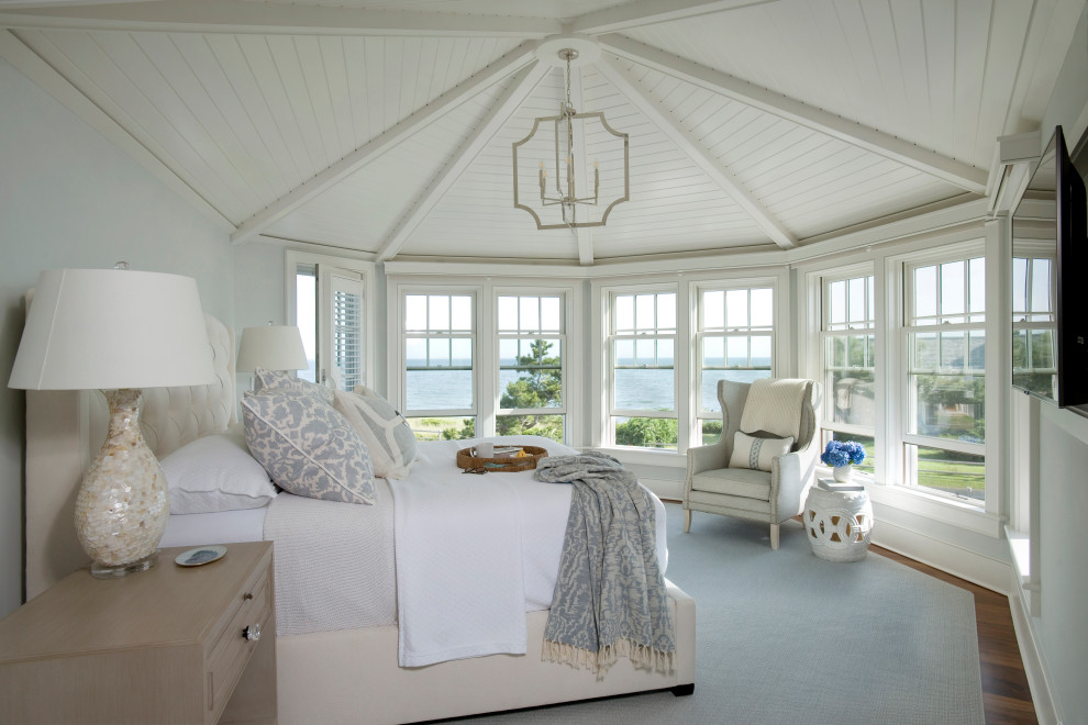 Beach style medium tone wood floor, brown floor, shiplap ceiling and vaulted ceiling bedroom photo in Boston with gray walls